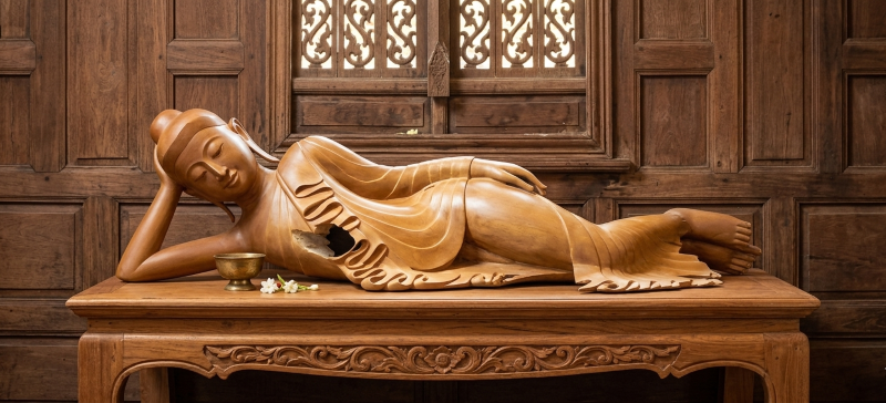 A serene Burmese reclining Buddha statue